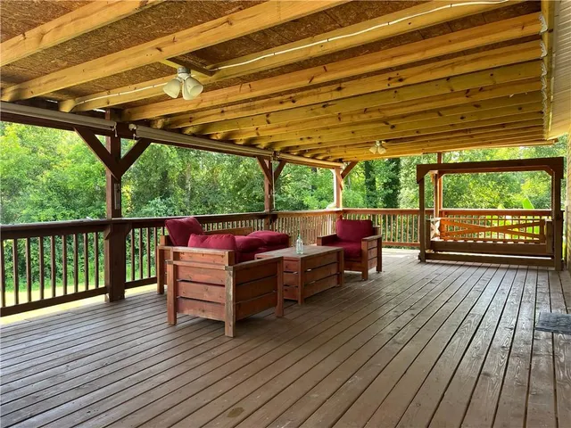 a view of a patio with table and chairs and wooden floor