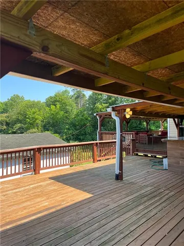 a view of a deck with wooden floor and outdoor space