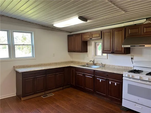 a kitchen with sink cabinets and stainless steel appliances
