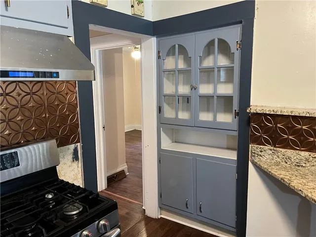 a kitchen with a refrigerator and a stove