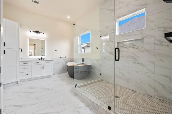 a bathroom with a sink a toilet and shower