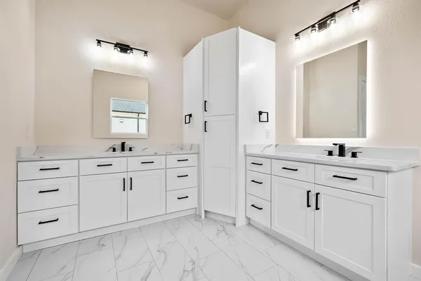 a bathroom with double vanity sink and mirror