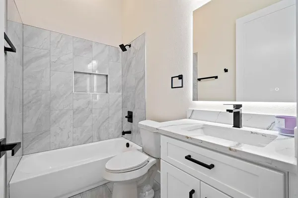 a bathroom with a sink a toilet and a bathtub