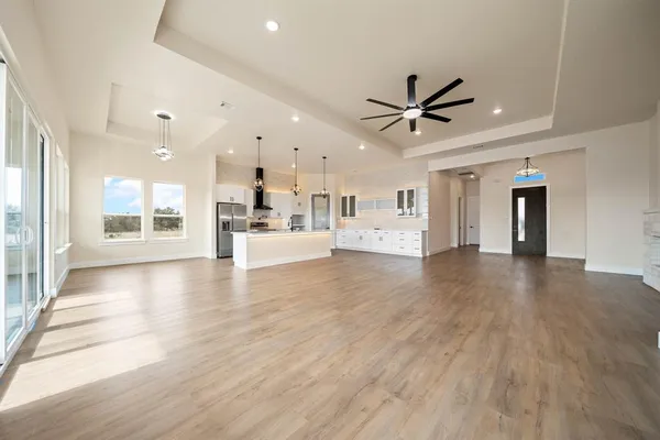 a view of a livingroom with kitchen and a stove