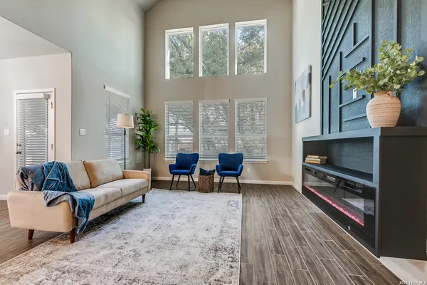 a living room with furniture and a potted plant