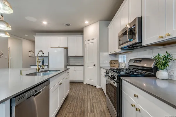 a kitchen with a sink stove and cabinets