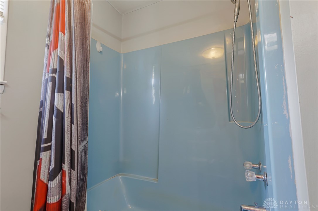 2390 Ridge Road Zanesville, OH 43701 - Photo 17 of 45 This bathroom features a shower with functional fixtures and a classic design.