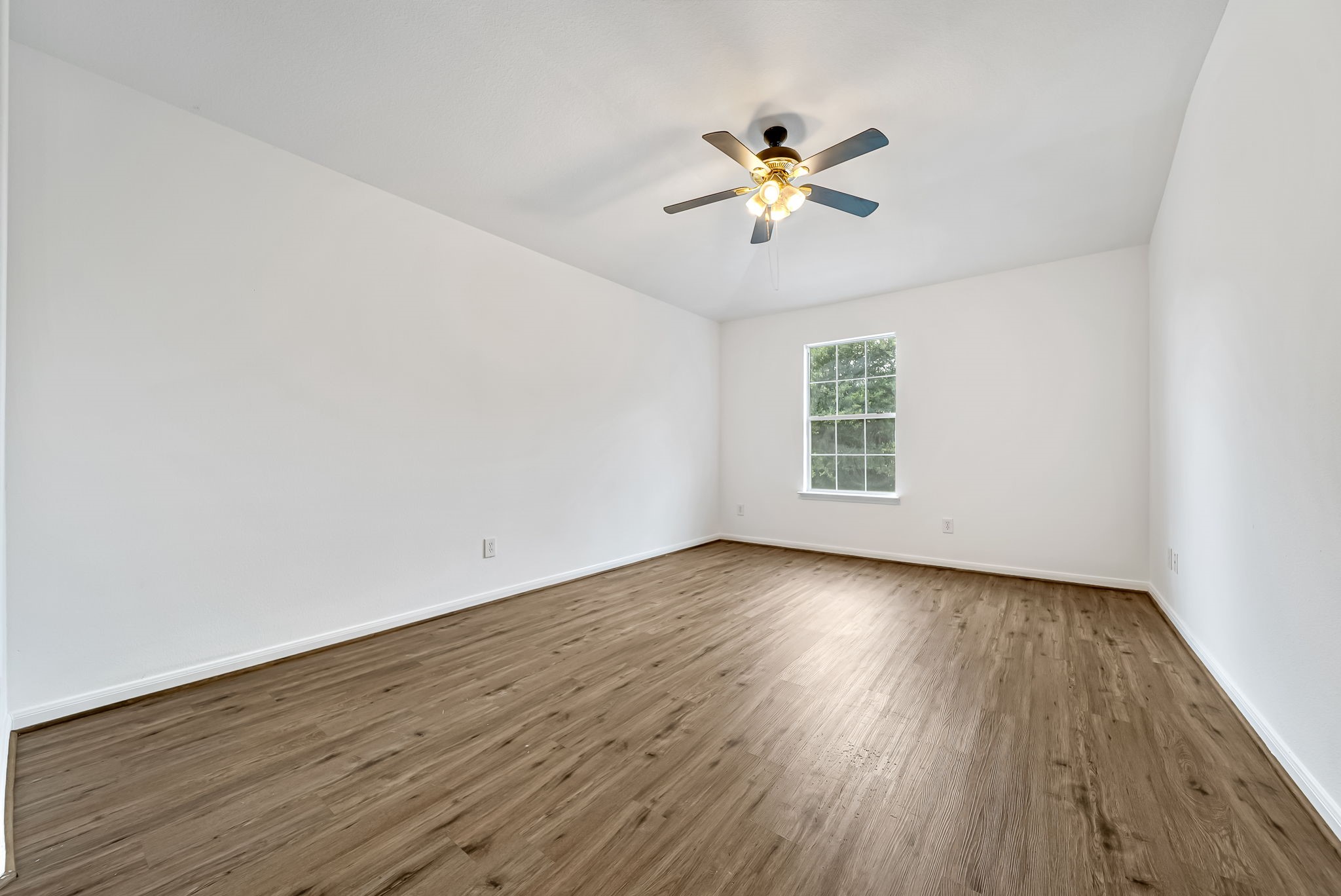 23526 Whispering Maple Drive Spring, TX 77373 - Photo 16 of 26 a view of an empty room with wooden floor and a window
