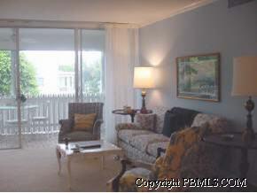 240 North County Road, Unit 203 Palm Beach, FL 33480 - Photo 1 of 1 a living room with furniture a lamp and a floor to ceiling window