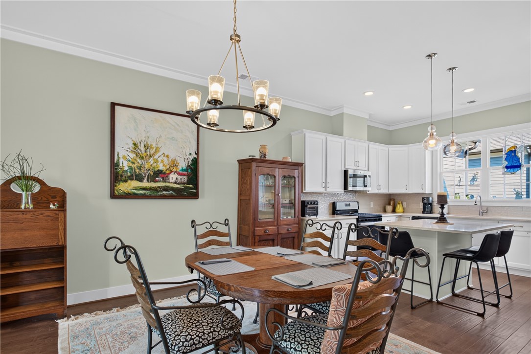 112 Tuttle Street Clemson, SC 29631 - Photo 11 of 46 Dine in a naturally illuminated space, flowing into a modern kitchen with high ceilings.