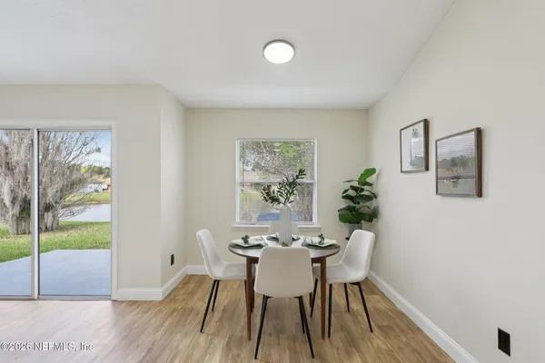 a view of a dining room with furniture window and wooden floor