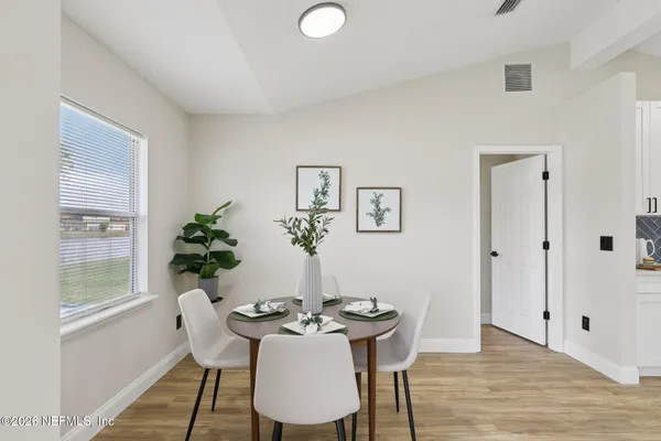 a view of a dining room with furniture window and wooden floor