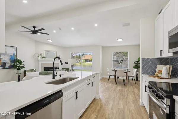 a large kitchen with stainless steel appliances lots of counter space and breakfast area