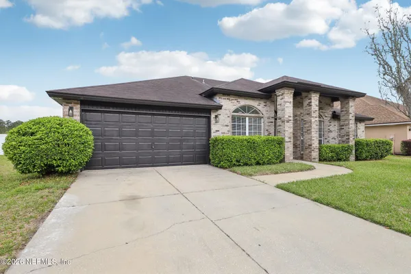 a front view of a house with a yard and garage