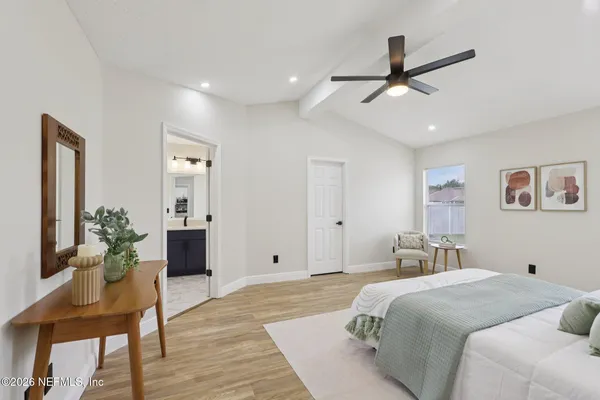a bedroom with a bed and a table in it