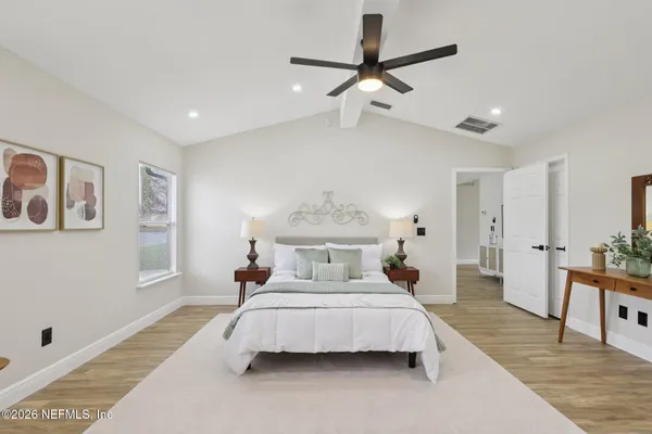 a bed room with a bed and a chandelier