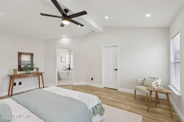 a bedroom with a bed and a table