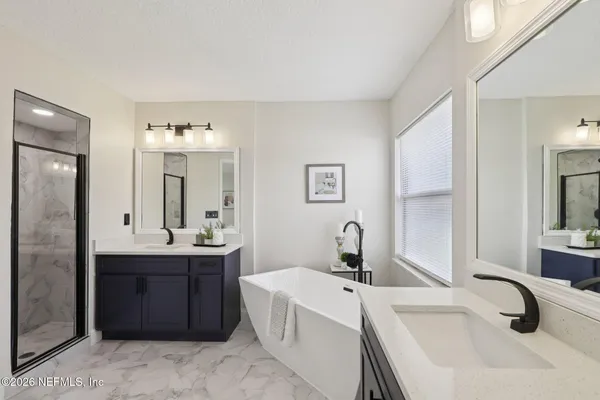 a bathroom with a double vanity sink and mirror