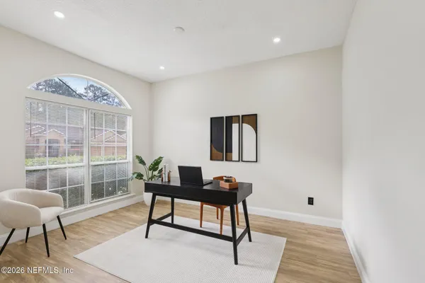 a workspace with wooden floor and a rug