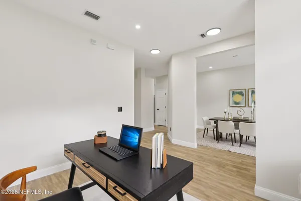 a view of a dining room with furniture and wooden floor