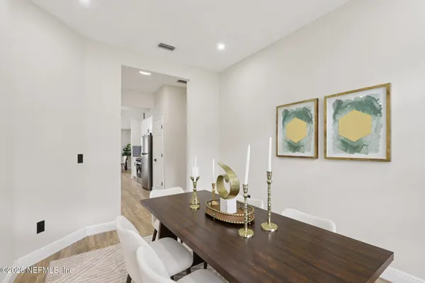 a view of a workspace with furniture and wooden floor
