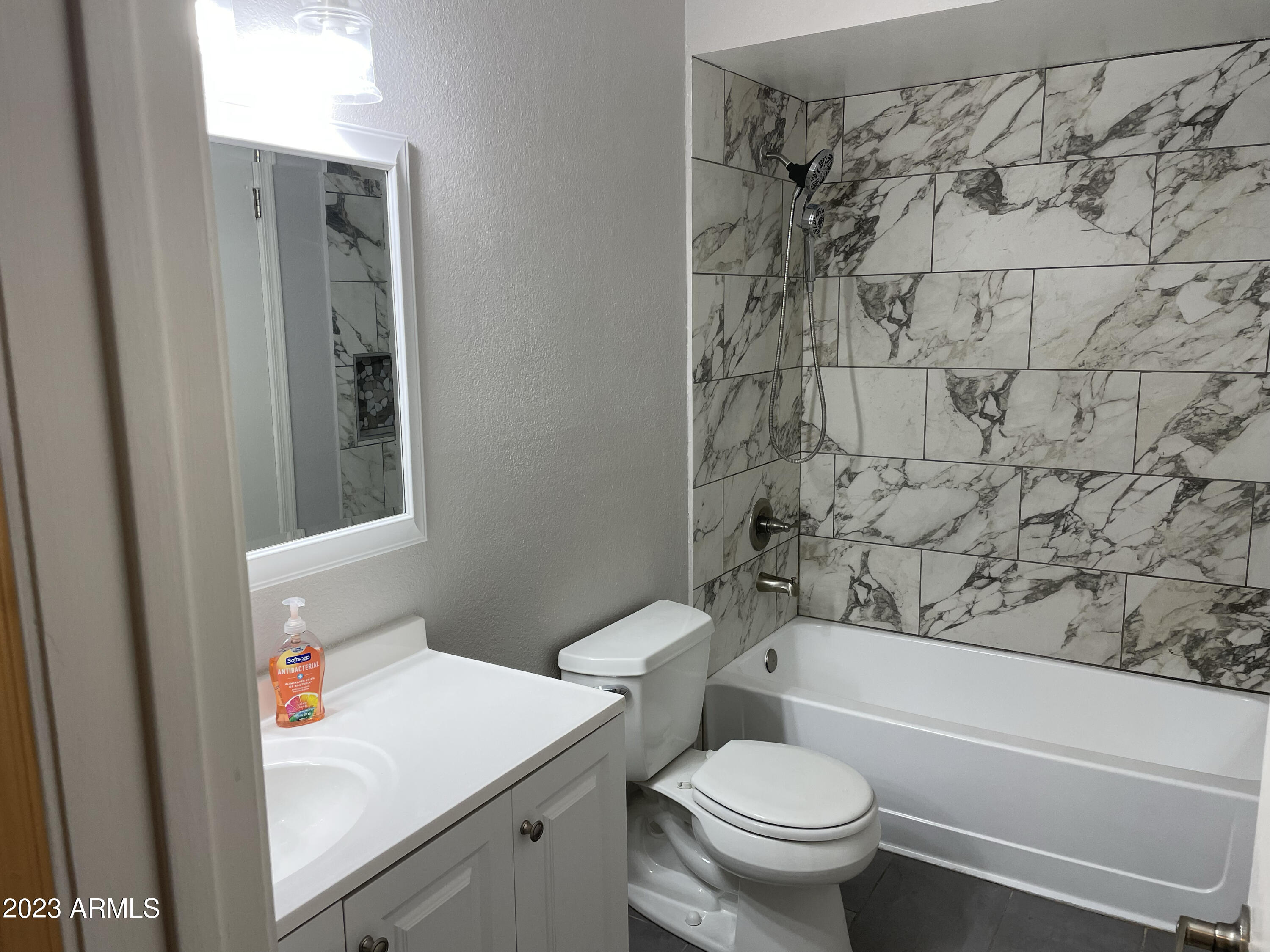 19820 North 13th Avenue, Unit 206 Phoenix, AZ 85027 - Photo 12 of 22 a white toilet sitting next to a bath tub and a shower curtain