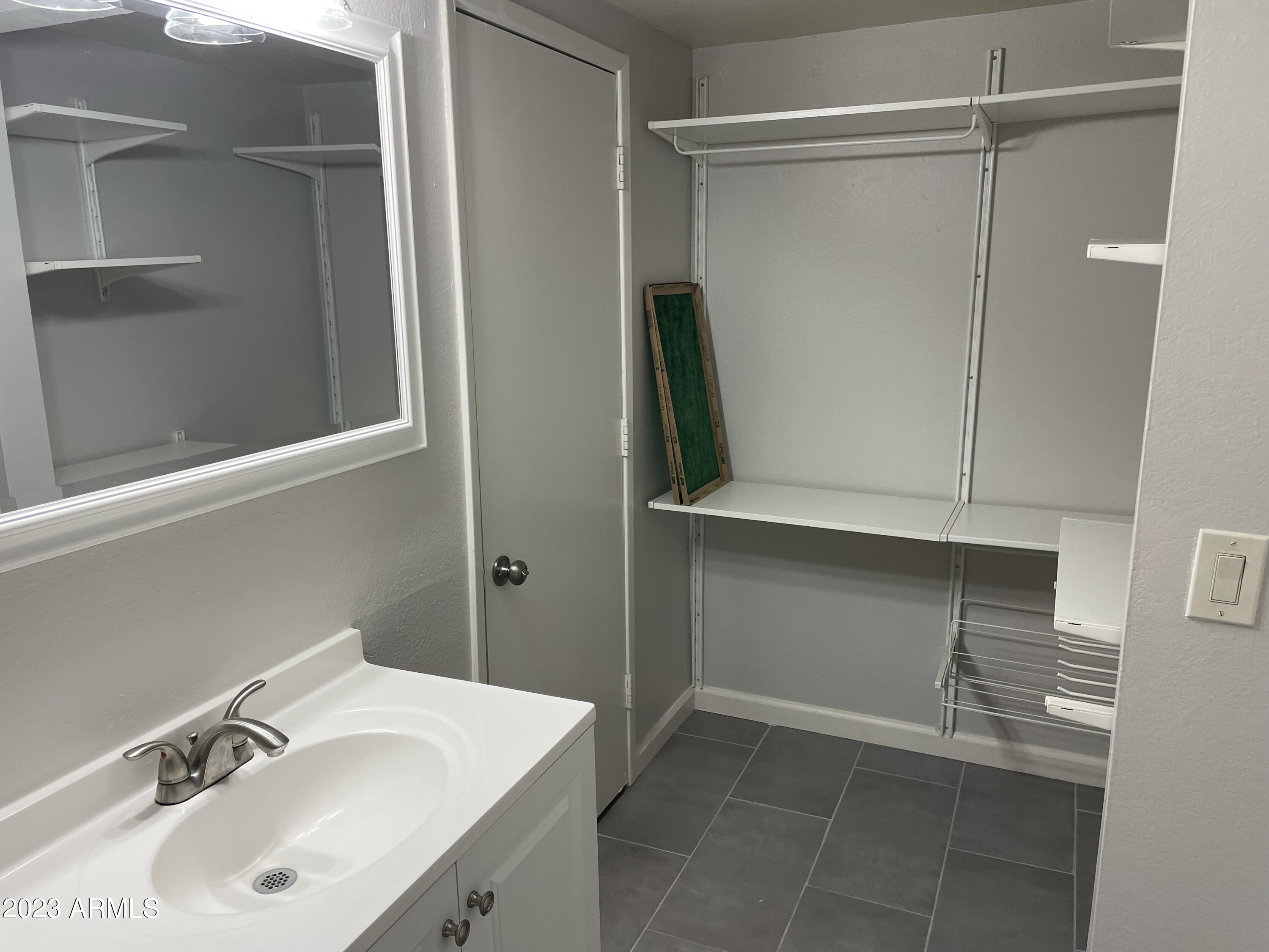 19820 North 13th Avenue, Unit 206 Phoenix, AZ 85027 - Photo 18 of 22 a bathroom with a sink and mirror