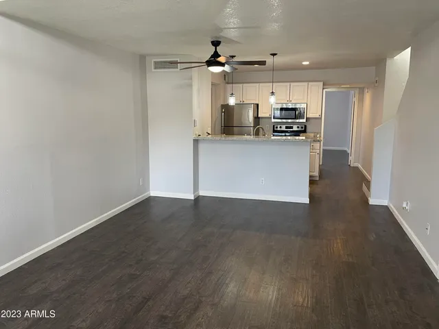 a view of a kitchen with a sink and a refrigerator