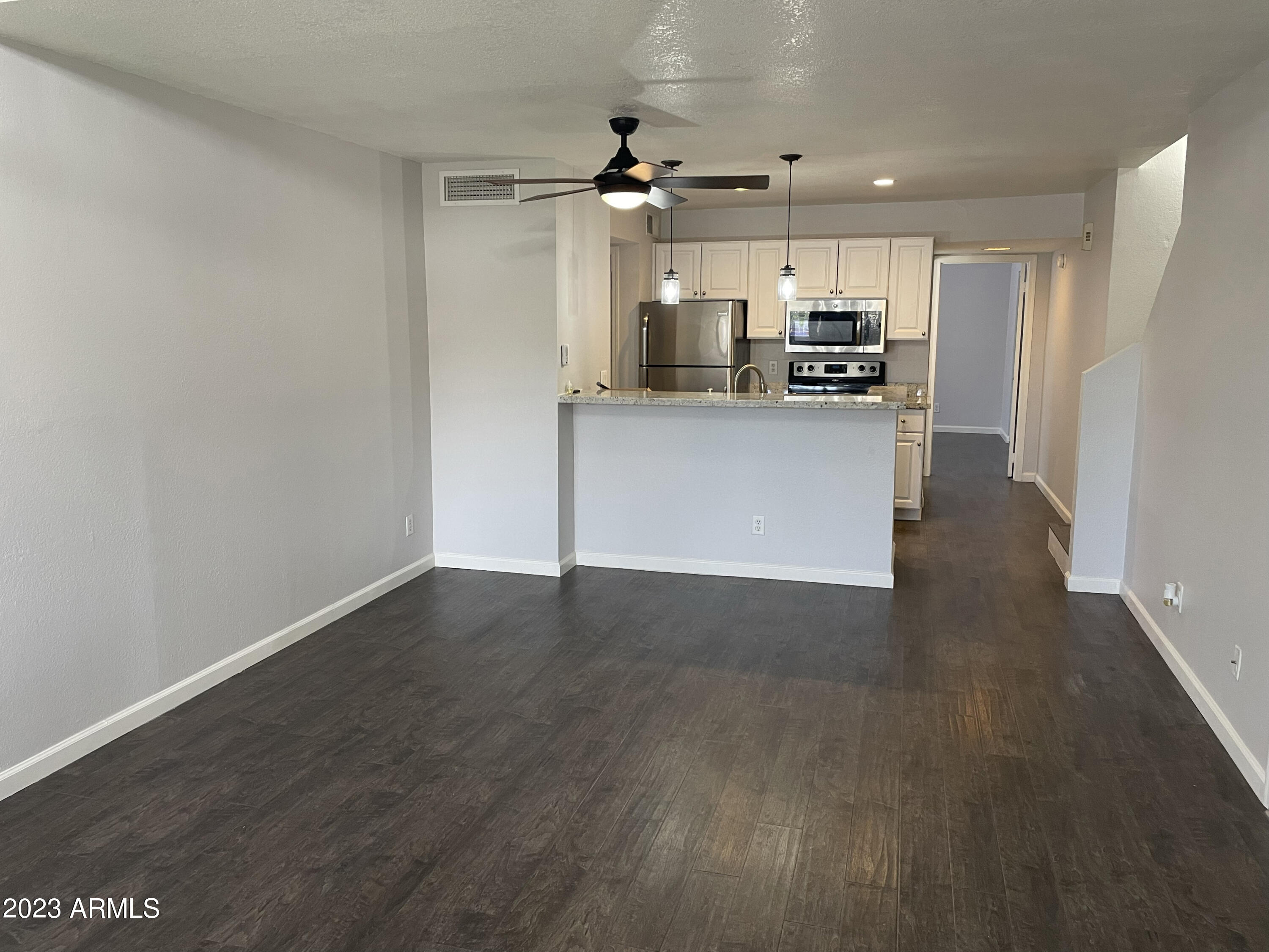 19820 North 13th Avenue, Unit 206 Phoenix, AZ 85027 - Photo 6 of 22 a view of a kitchen with a sink and a refrigerator