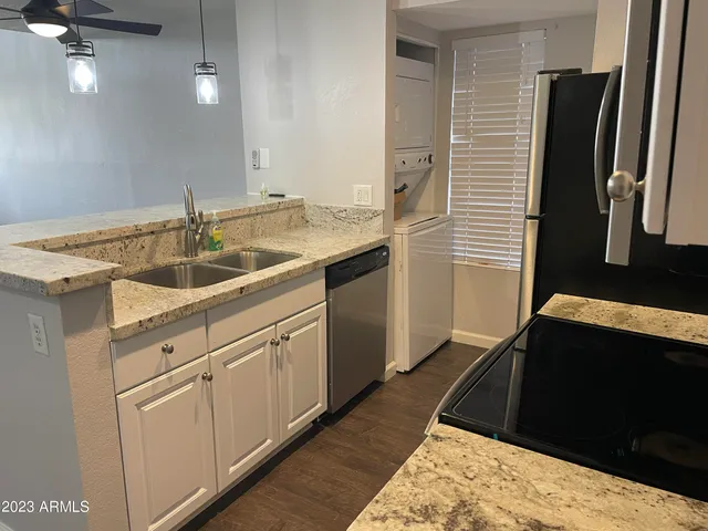 a kitchen with a sink and a refrigerator