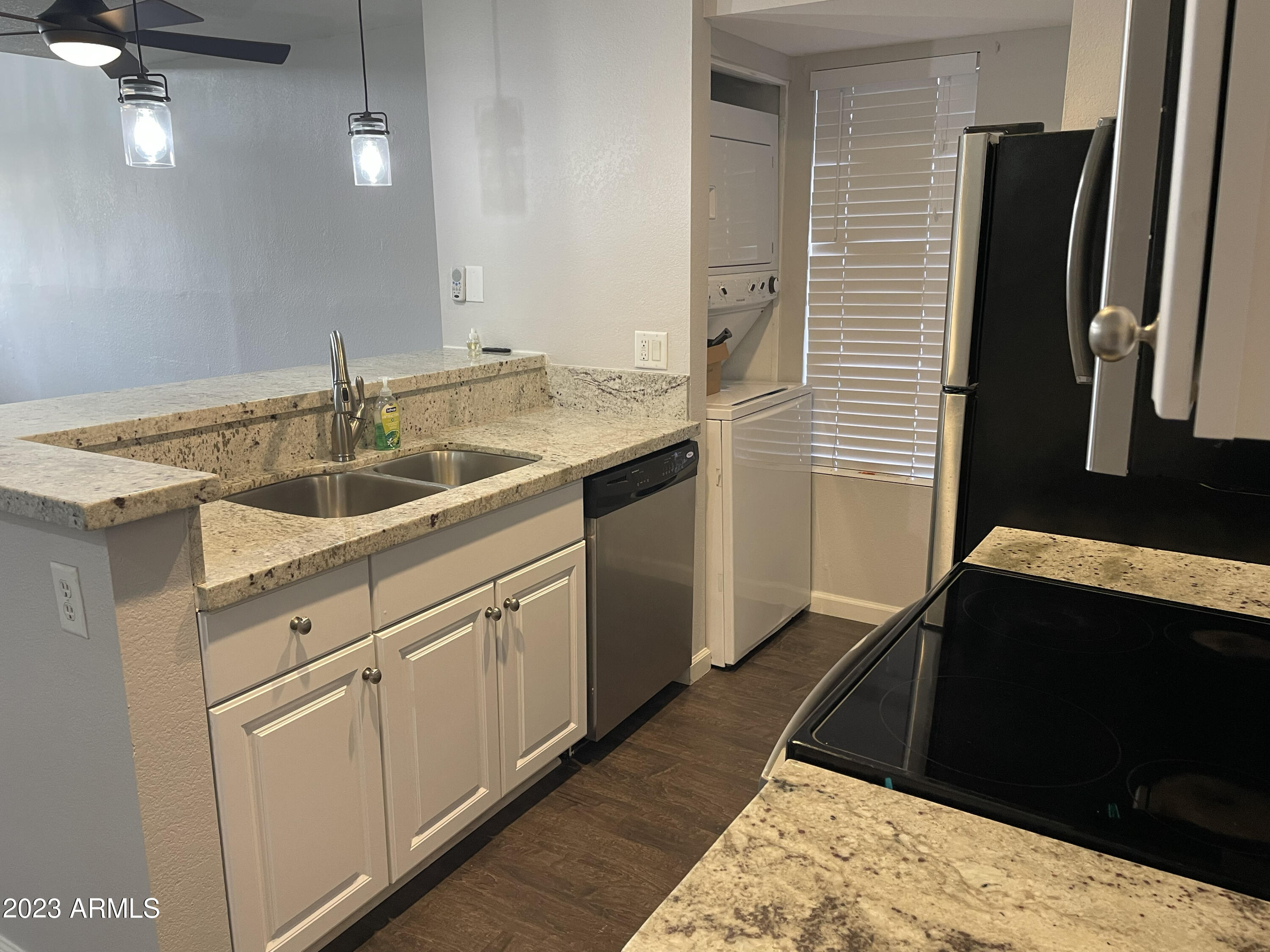 19820 North 13th Avenue, Unit 206 Phoenix, AZ 85027 - Photo 8 of 22 a kitchen with a sink and a refrigerator