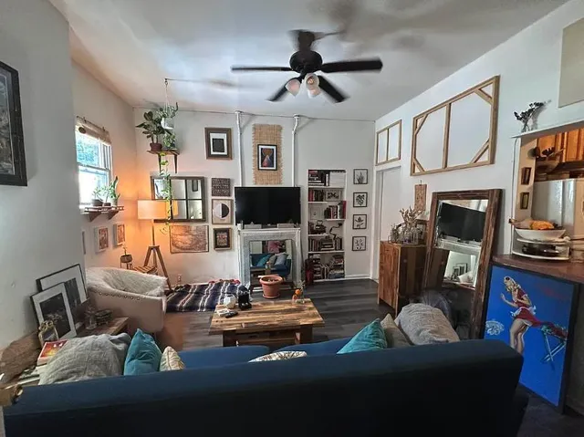 a living room with furniture fireplace and flat screen tv