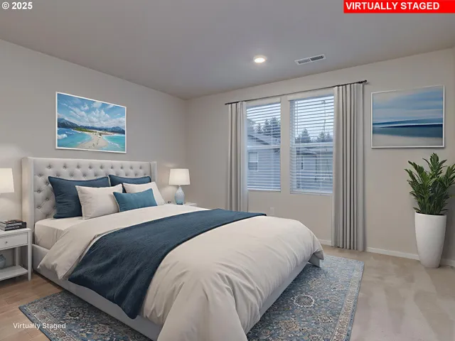 a bedroom with a large bed and a potted plant