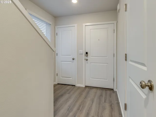 a view of a room with wooden floor and entryway