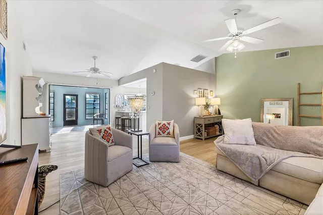 a dining hall with granite countertop a stove top oven a sink a dining table and chairs with wooden floor