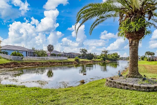 a living room with furniture and a dining table with wooden floor