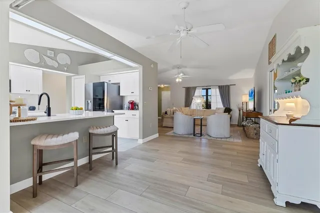 a kitchen with stainless steel appliances kitchen island granite countertop a refrigerator and a sink