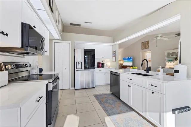 a kitchen with a stove a sink and a refrigerator