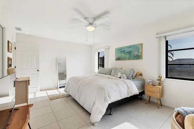 a bedroom with a bed and a view of kitchen