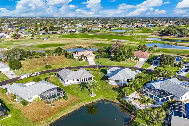 a view of a swimming pool with a lot of trees in the background