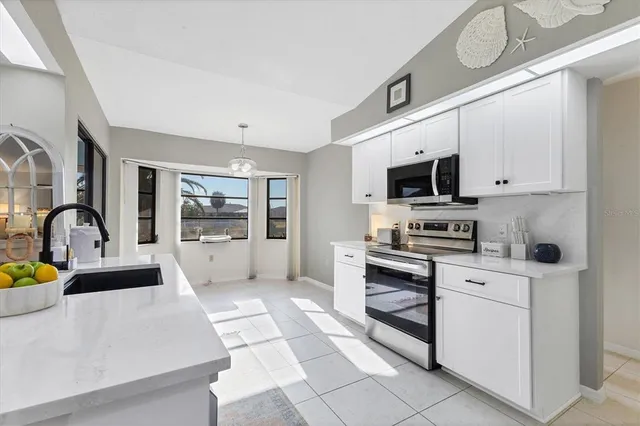a view of an empty room with a window and a chandelier