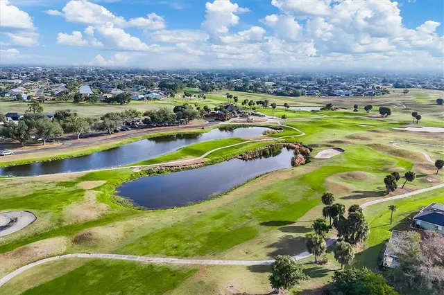 a green field with trees in the background