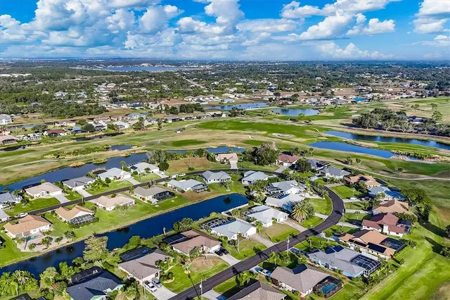 an aerial view of a house with swimming pool garden and patio