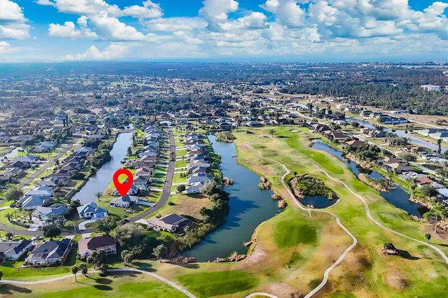 a view of a house with a big yard and large trees