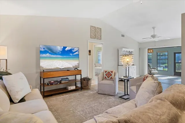 a living room with furniture and a chandelier