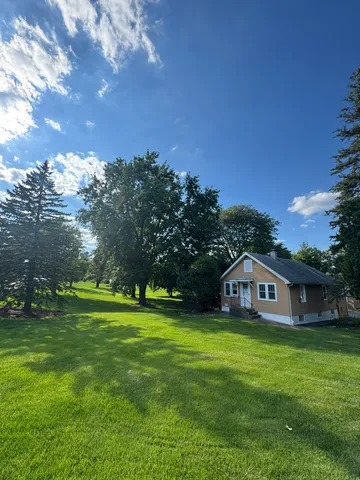 a view of a house with a big yard