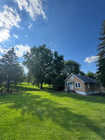 a view of a house with a big yard