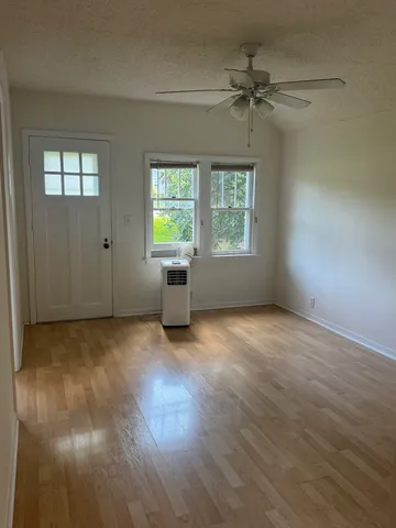 an empty room with windows and closet