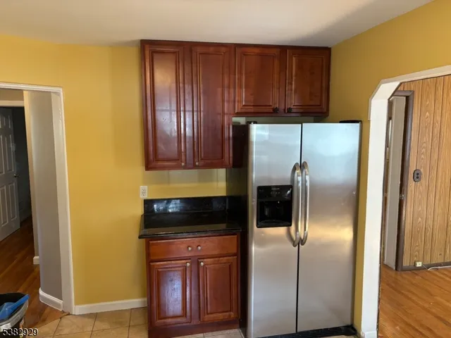 a kitchen with a refrigerator a microwave and cabinets
