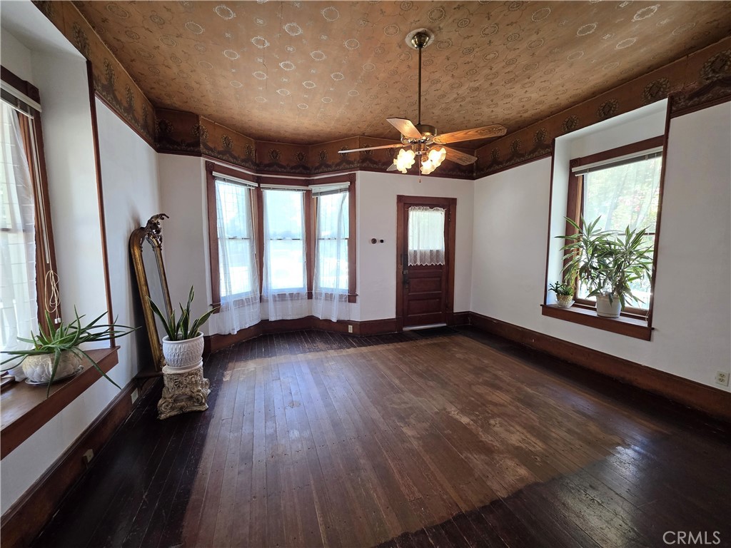 1414 Marin Street Corning, CA 96021 - Photo 2 of 43 a view of an empty room with wooden floor and a window